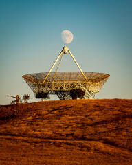 full moonrise over satellite dish