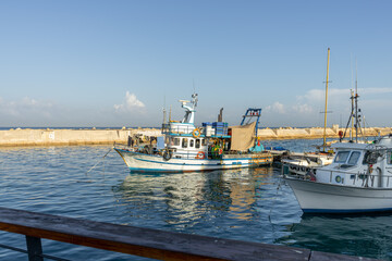 Fishing boats coming into the Jaffa - Namal Yafo port in Tel Aviv, Israel. Jaffa, the oldest seaport in the world.