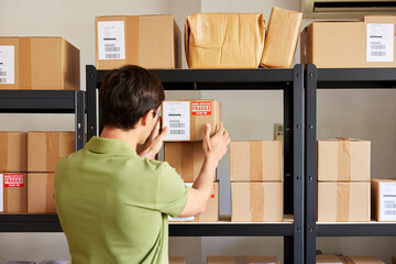 Logistic manager putting parcel on shelf
