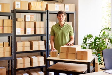 Cheerful man behind table with parcels