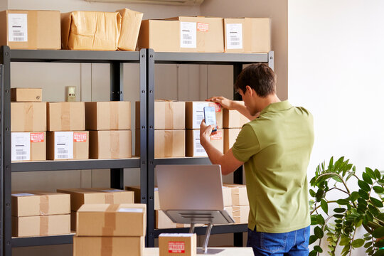 Logistic manager shooting boxes on shelves