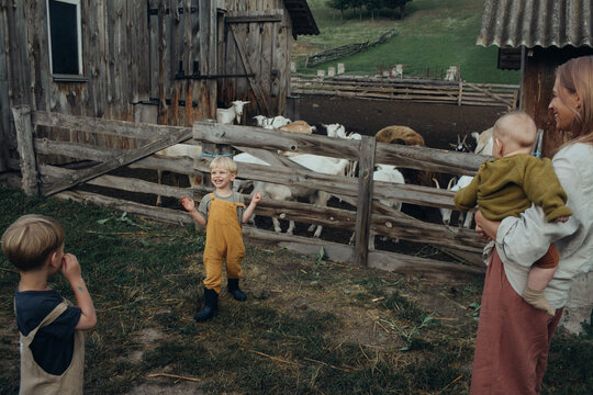 Little boy laughs out loud and enjoys a walk on the farm