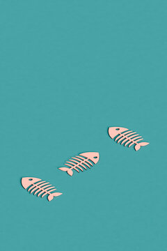 three pink cartoonish fishbones with copy space
