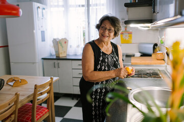 Smiley woman preparing a meal in her kitchen