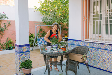 Woman preparing flowers in her terrace