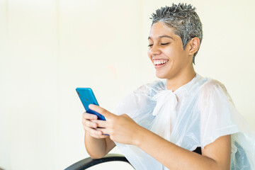 Young woman in the beauty salon in the process of hair bleaching 