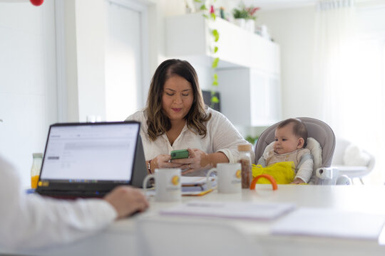 Woman With Baby Working From Home 