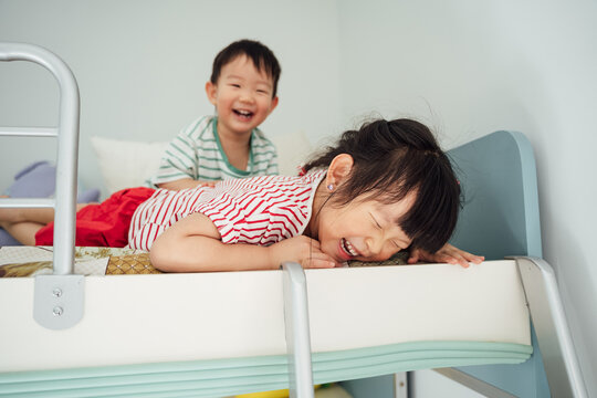 Cute little boy and girl playing at home