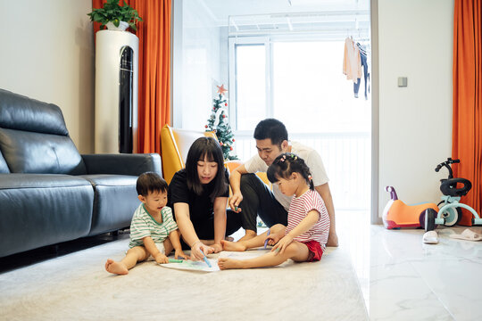 Cute kids drawing with their parents