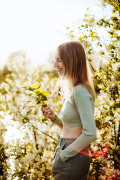 Carefree young woman summer portrait with blossom flowers