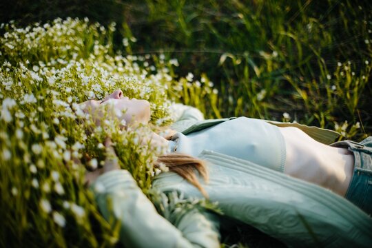 Carefree woman lying on grass - Springtime lifestyle