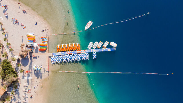 aerial view of a long pier with colourful boats