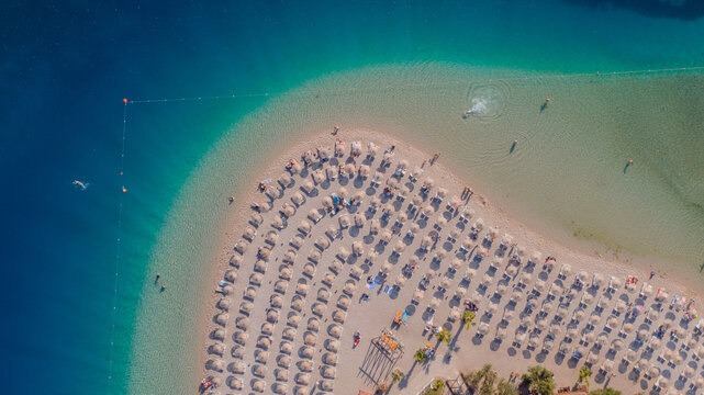 close-up of a beach at peninsula - azure water and rows of chairs