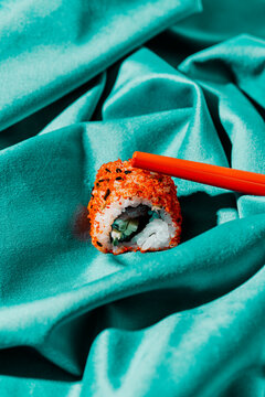 Red Chopsticks And Piece Of Sushi