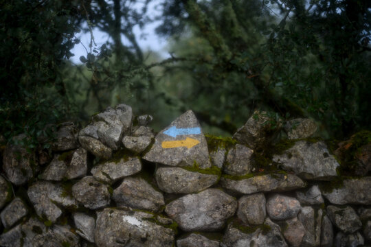 Camino de Santiago typical arrows in yellow and blue
