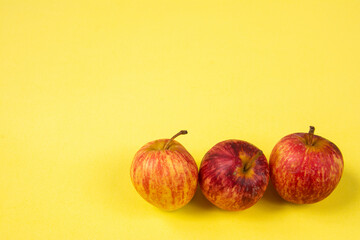Delicious ripe apples with yellow background