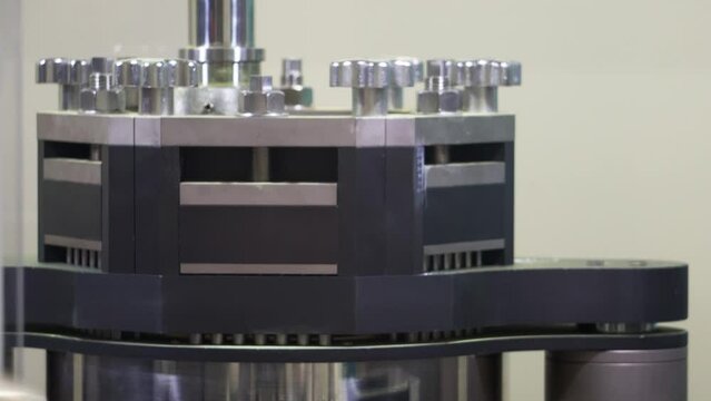 Medical encapsulation machine. Manufacturing of drugs. Pharmaceuticals. Dosator machine with segments. The dosing block moves downwards. Ejected powder in the capsules by dosator. Production line