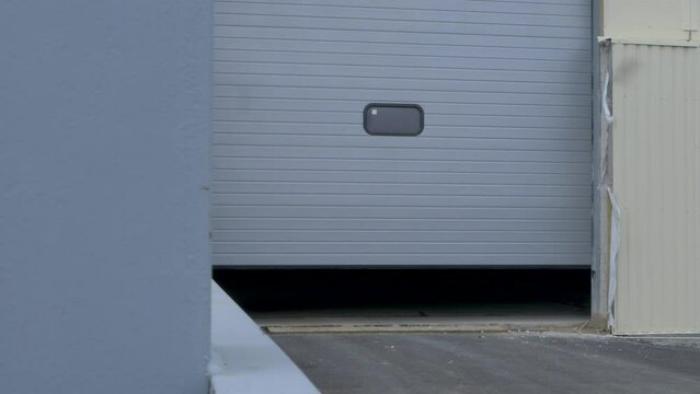 Metal door in large heavy industry plant. Roller security shutter, coiling door or sectional overhead door