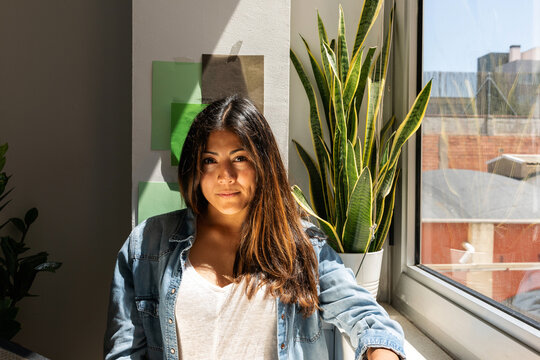 Latin pretty woman at the window portrait