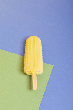 Yellow popsicle on a background