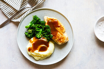 Plate of food with gravy chicken and veg