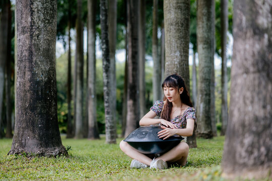Woman Playing The handpan