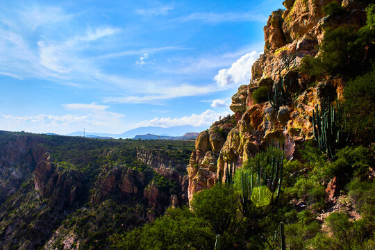 mountain with monolith with stone face and mountains in the background in sunny day, zimapan hidalgo watchman monolith 