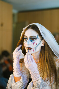 An actress  in front of a mirror makes her make-up