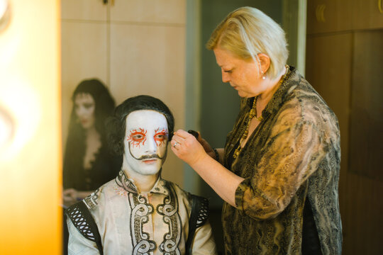 An actor and a make-up artist in front of a mirror