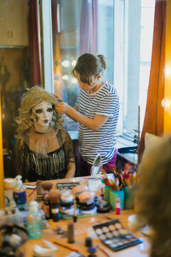An actress and a make-up artist in front of a mirror