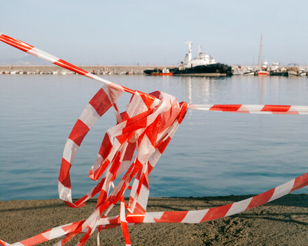 Plastic fencing and warning tape in the port