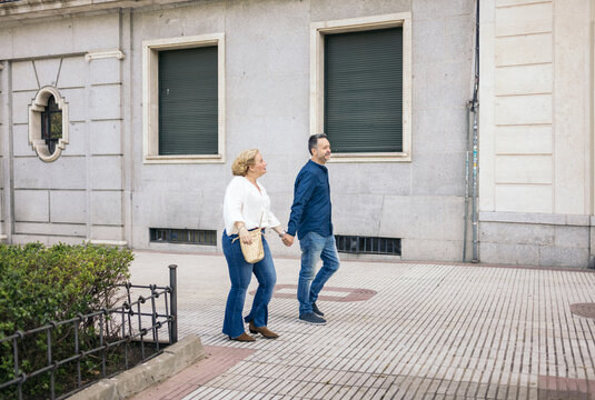 Middle-aged couple walking in the city