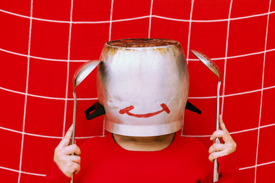 Abstract portrait of a young woman wearing cooking supplies
