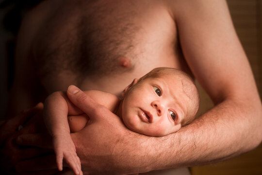 Anonymous father holding newborn