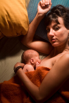 Breastfeeding mother looking at camera