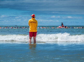 Lifesaver watching swimmers at a beach in Australia