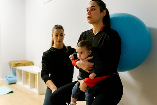 Mother and baby attending a postpartum recovery class