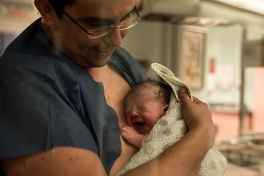 Father with a newborn baby in his arms
