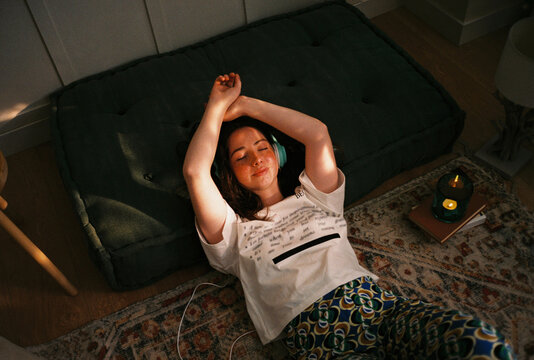 User-generated content teen resting on floor listening music