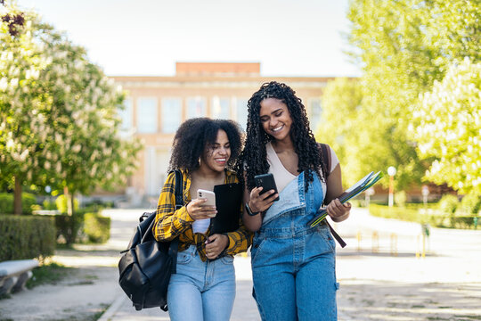 College friends laugh at phone text