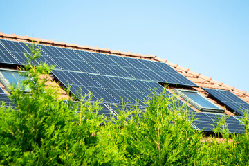 House roof with photovoltaic modules. Historic farm house with modern solar panels on roof and wall...
