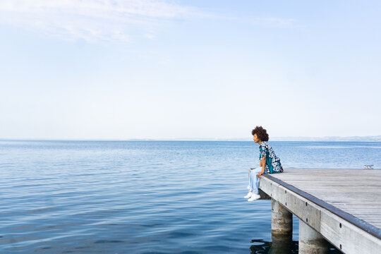 Cool woman relaxing on a pier
