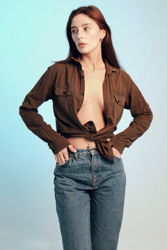 Young woman in unbuttoned shirt and jeans