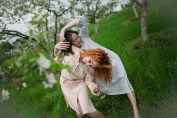 two women contemporary dancers dancing in a blossom garden