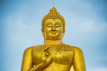 Fototapeta na wymiar Close up the big golden Buddha statue of Thaksin Mingmongkol, Narathiwat province, Thailand.