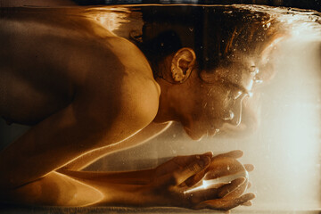 Underwater woman Nude with beautiful yellow light from the lamp 