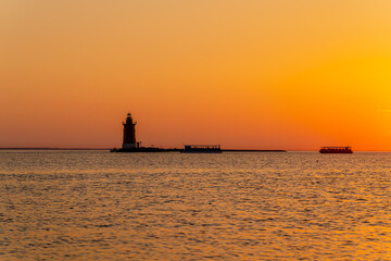 Fototapeta premium Rehoboth Beach Sunset at Cape Henlopen Harbor of Refuge Lighthouse