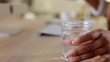 Pouring water for hydration and refreshment. Hands holding bottle and glass with refreshing beverage. Businesswoman feeling thirsty and enjoying an alkaline drink to get daily intake of liquid