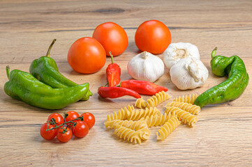 still life of different vegetables and italian pasta