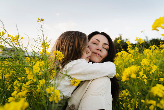 Loving Child Hugging Her Mom